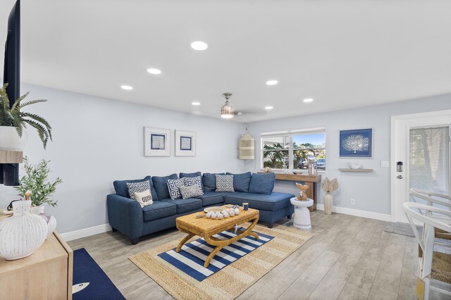 living room with sink and light hardwood / wood-style floors