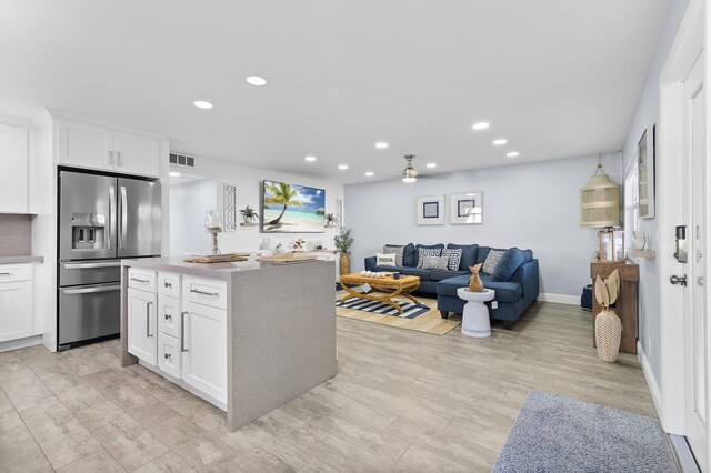 kitchen with appliances with stainless steel finishes, sink, white cabinets, and decorative backsplash