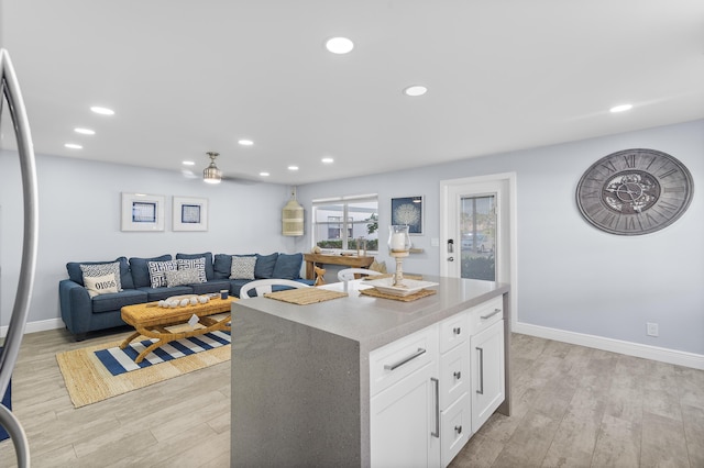 kitchen featuring light wood-style flooring, white cabinetry, and recessed lighting