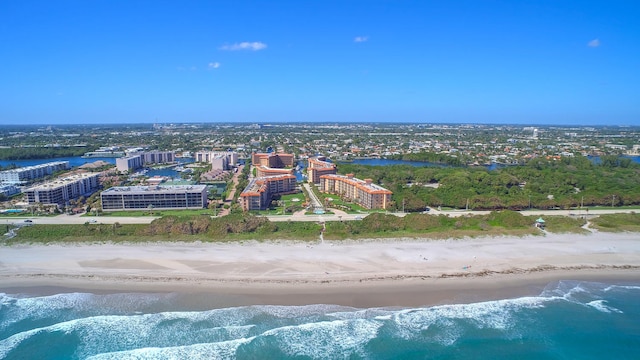 drone / aerial view featuring a water view and a beach view