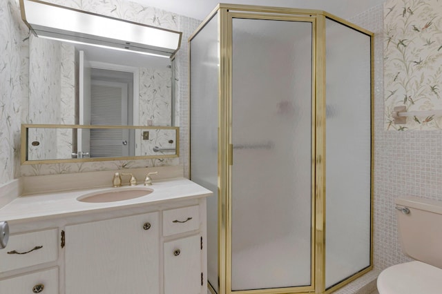 2871 N Ocean Blvd Unit C103, Boca Raton, FL 33431 - bathroom featuring toilet, wallpapered walls, a shower stall, and vanity