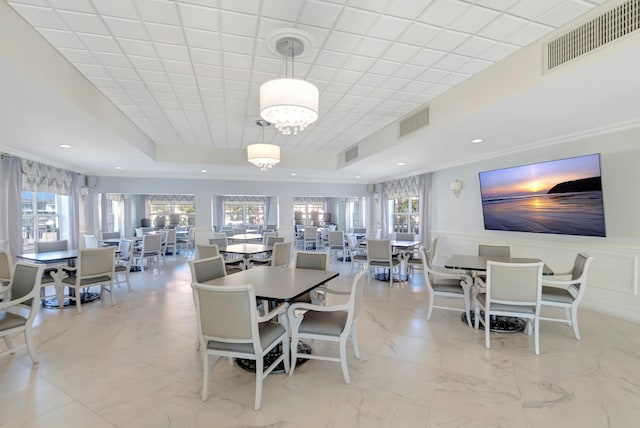 2871 N Ocean Blvd Unit C103, Boca Raton, FL 33431 - dining space featuring marble finish floors, a tray ceiling, recessed lighting, a wainscoted wall, and a chandelier