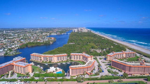 drone / aerial view featuring a water view and a beach view