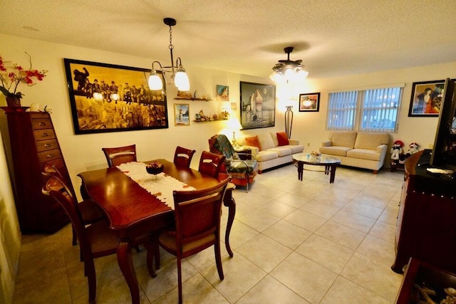 dining space featuring light tile patterned floors and a textured ceiling