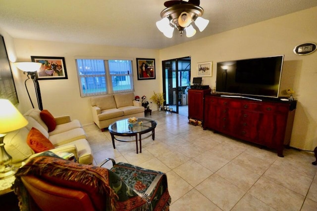 living room featuring light tile patterned flooring and ceiling fan