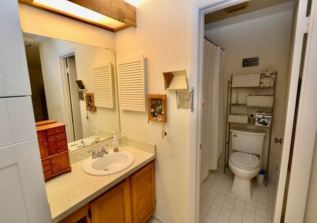 bathroom featuring vanity, tile patterned floors, and toilet