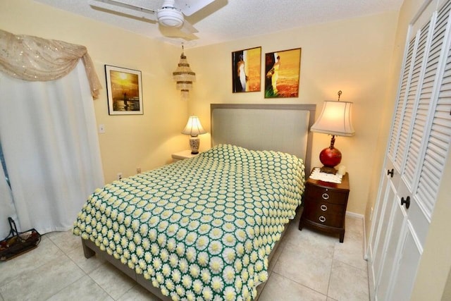 tiled bedroom with a closet and a textured ceiling