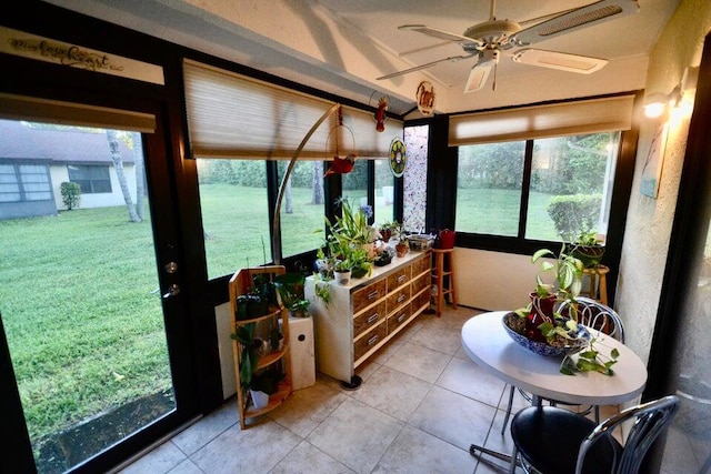 sunroom / solarium featuring ceiling fan