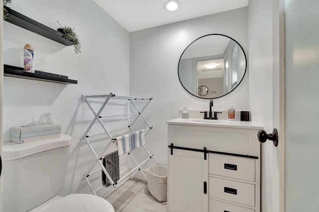 bathroom featuring vanity and toilet