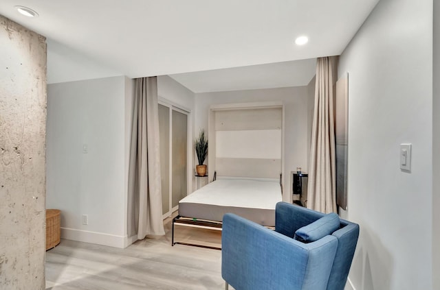 bedroom featuring light hardwood / wood-style floors and a closet