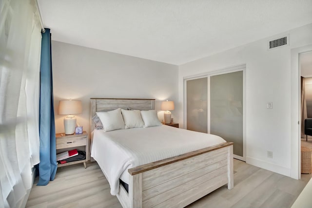 bedroom featuring light hardwood / wood-style floors and a closet