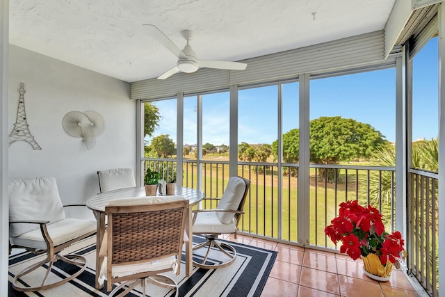 sunroom / solarium featuring a wealth of natural light and ceiling fan