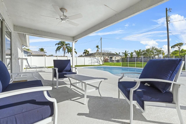 view of pool with an outdoor living space, a patio, and ceiling fan