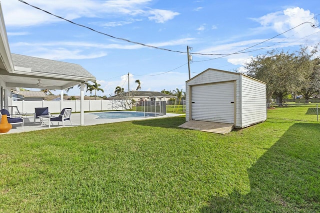 view of yard featuring a fenced in pool, a storage shed, and a patio area