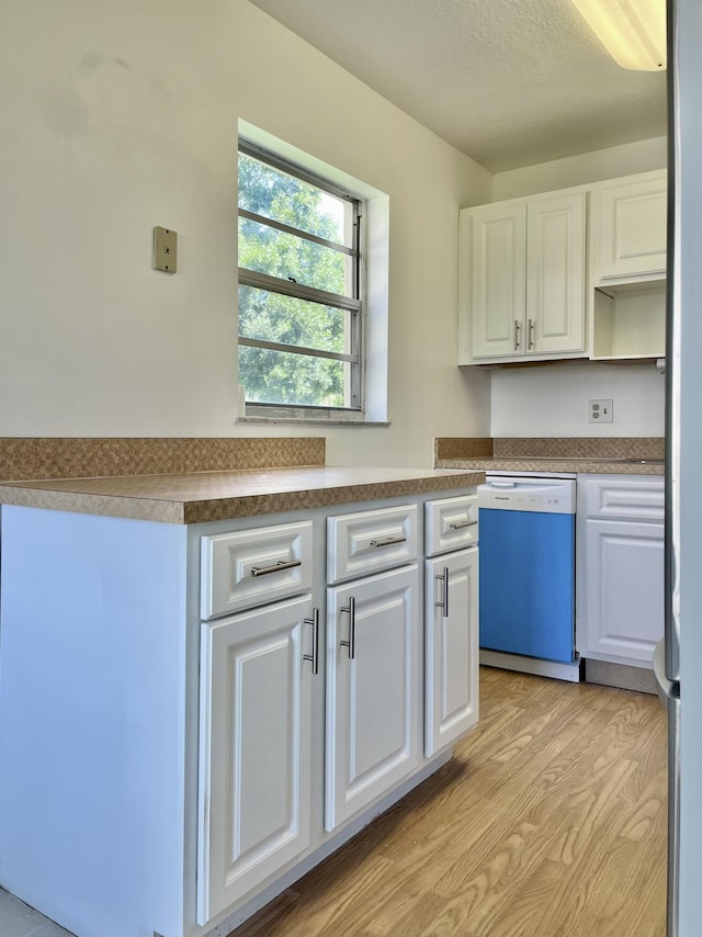 kitchen with white cabinetry, white dishwasher, and light wood-type flooring