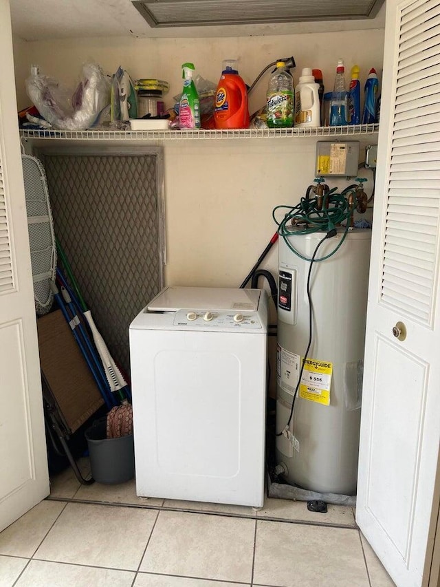 laundry room with washer / dryer, electric water heater, and light tile patterned floors