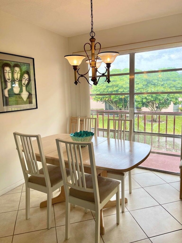 tiled dining area with a chandelier