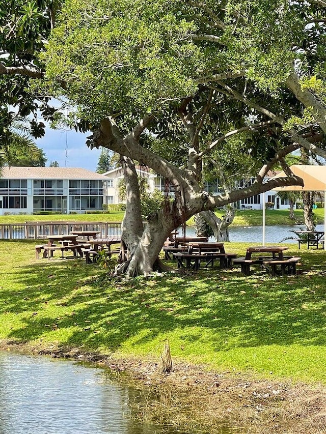 view of home's community featuring a water view and a yard