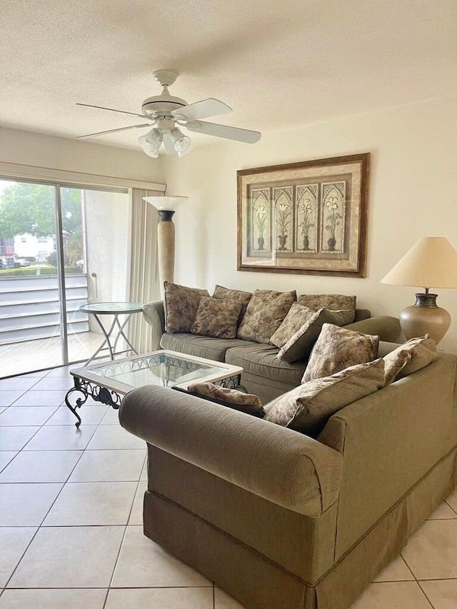 tiled living room with ceiling fan and a textured ceiling