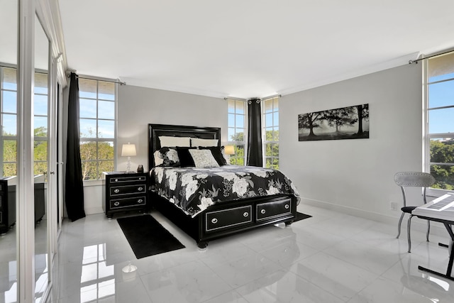 bedroom featuring multiple windows and ornamental molding