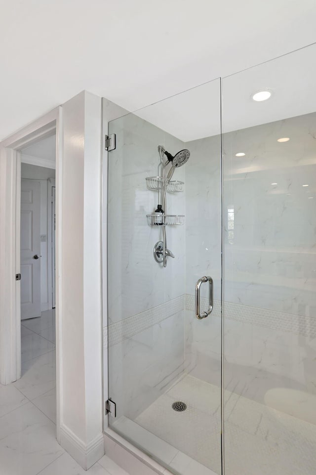 bathroom featuring a shower with shower door