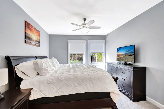 bedroom with ceiling fan and light colored carpet