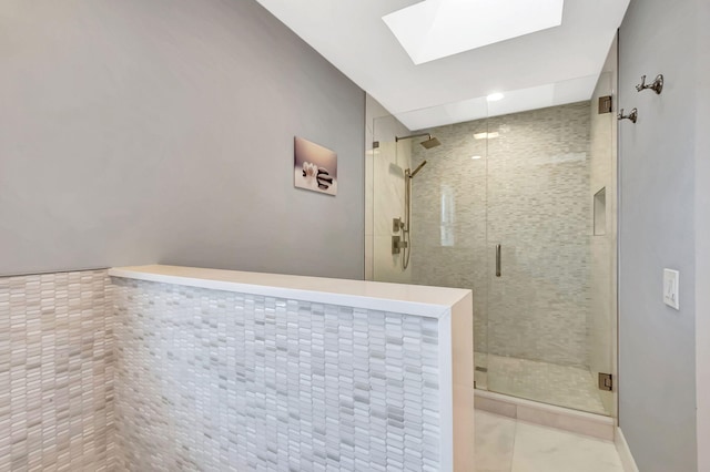 bathroom featuring an enclosed shower and a skylight