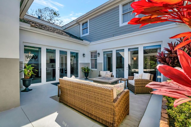 view of patio / terrace with an outdoor living space with a fire pit and french doors