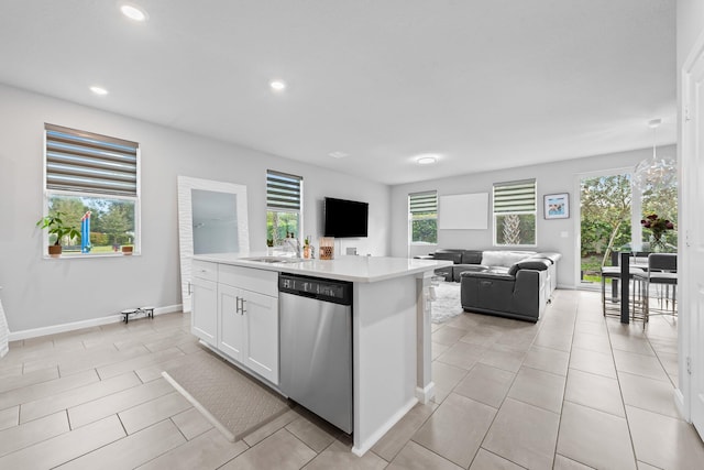 kitchen with white cabinets, sink, dishwasher, and a center island with sink