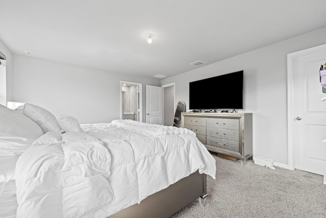 carpeted bedroom with ensuite bathroom