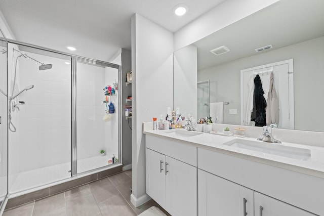 bathroom with vanity and a shower with shower door