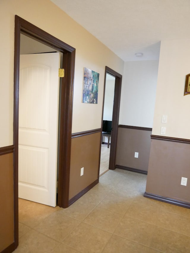 corridor with light tile patterned flooring