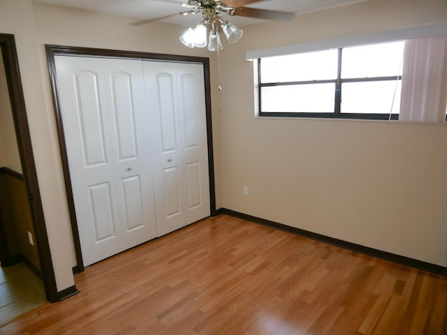 unfurnished bedroom featuring a closet, ceiling fan, and light hardwood / wood-style flooring