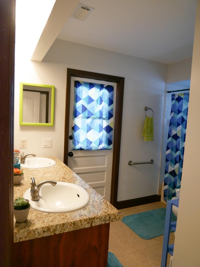 bathroom featuring vanity and tile patterned flooring