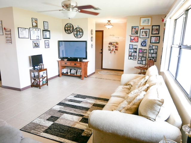 tiled living room with ceiling fan