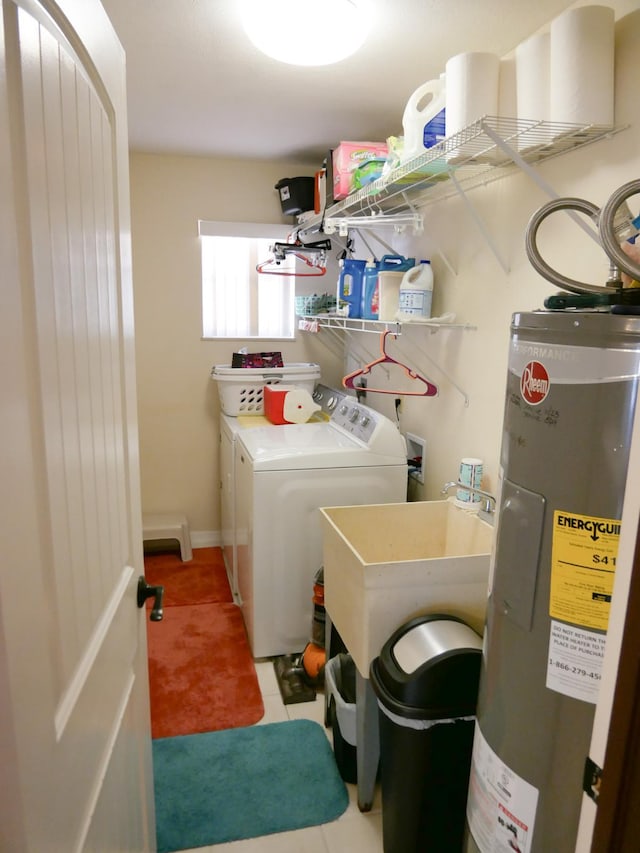 washroom with sink, washer and clothes dryer, tile patterned floors, and water heater