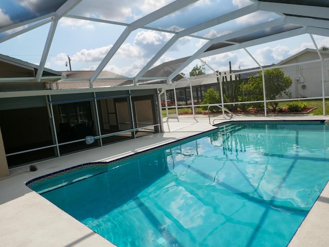 view of pool featuring a patio and glass enclosure