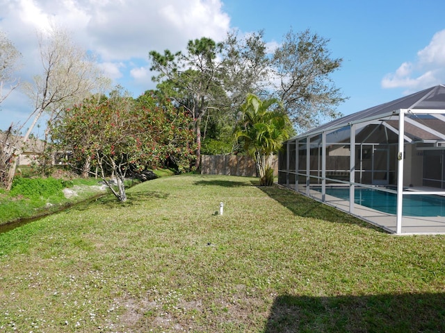 view of yard with glass enclosure