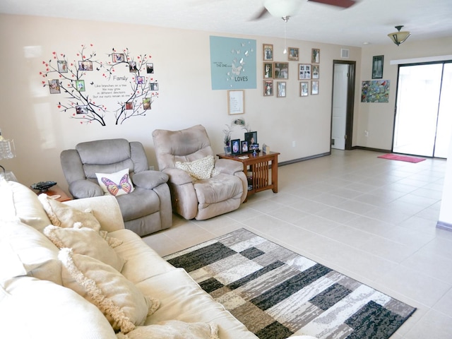 living room with ceiling fan and light tile patterned flooring