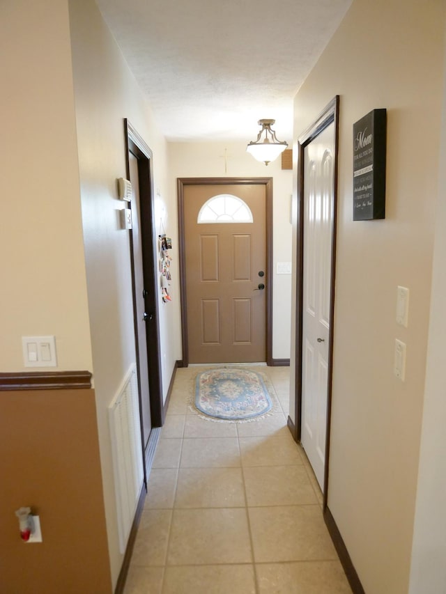 doorway to outside featuring light tile patterned floors