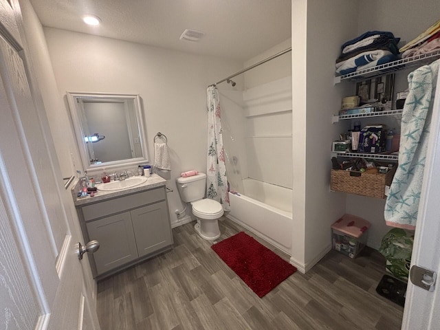 full bathroom featuring shower / tub combo with curtain, vanity, hardwood / wood-style flooring, and toilet