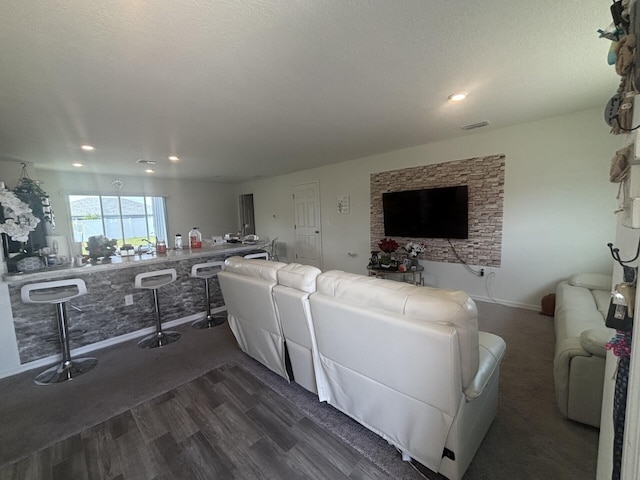 living room with dark hardwood / wood-style floors and a textured ceiling