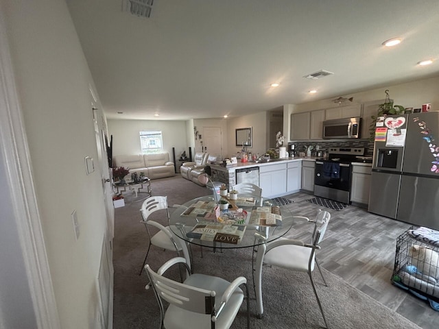 dining room featuring hardwood / wood-style flooring and sink