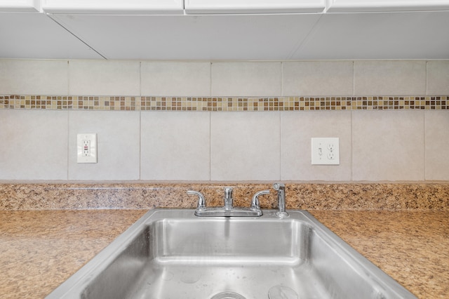 interior details featuring sink and white cabinets