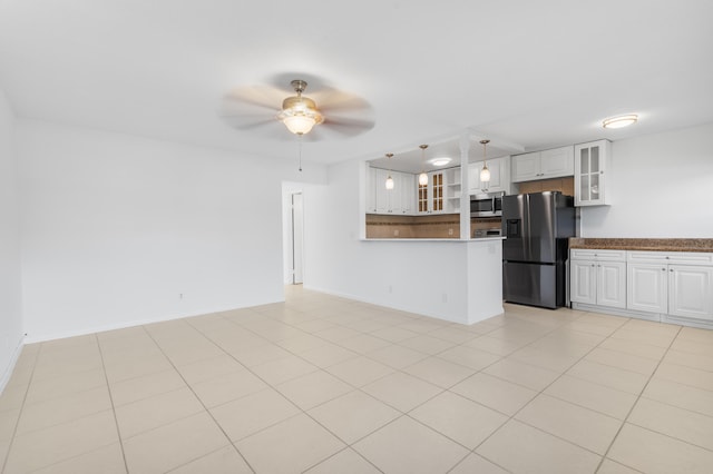 kitchen featuring white cabinetry, hanging light fixtures, light tile patterned floors, appliances with stainless steel finishes, and ceiling fan