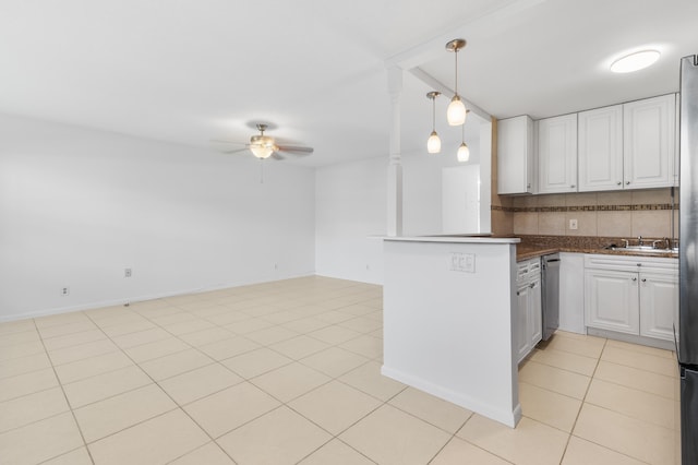 kitchen with pendant lighting, light tile patterned floors, white cabinetry, decorative backsplash, and kitchen peninsula