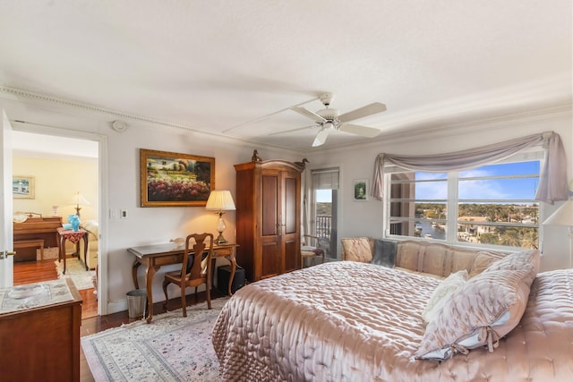 bedroom featuring hardwood / wood-style floors, ornamental molding, and ceiling fan