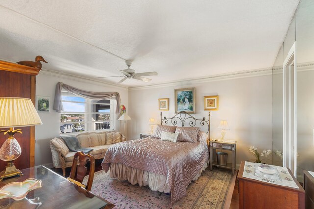 bedroom featuring ceiling fan, ornamental molding, and hardwood / wood-style floors