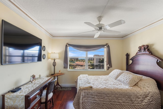 bedroom featuring dark hardwood / wood-style flooring, ceiling fan, ornamental molding, and a textured ceiling