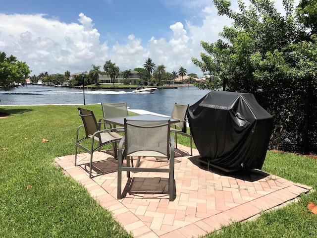 view of patio featuring a water view, area for grilling, and a swimming pool